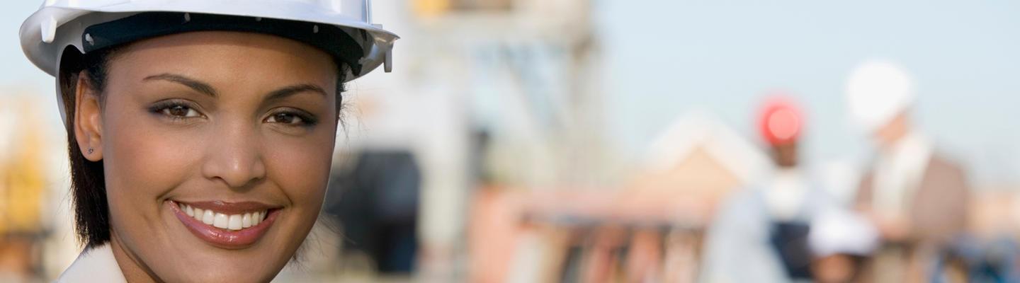 Woman wearing a hard hat and smiling